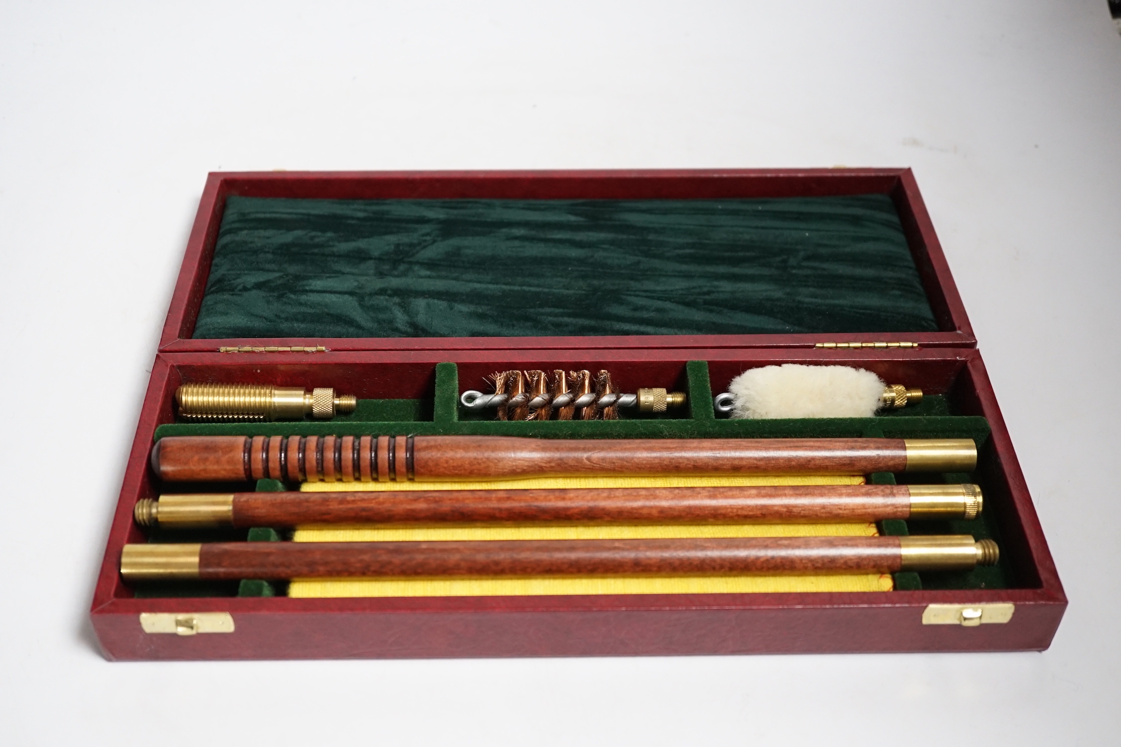 Three copper powder flasks, a leather powder flask, two powder measures and two cases of cleaning tools